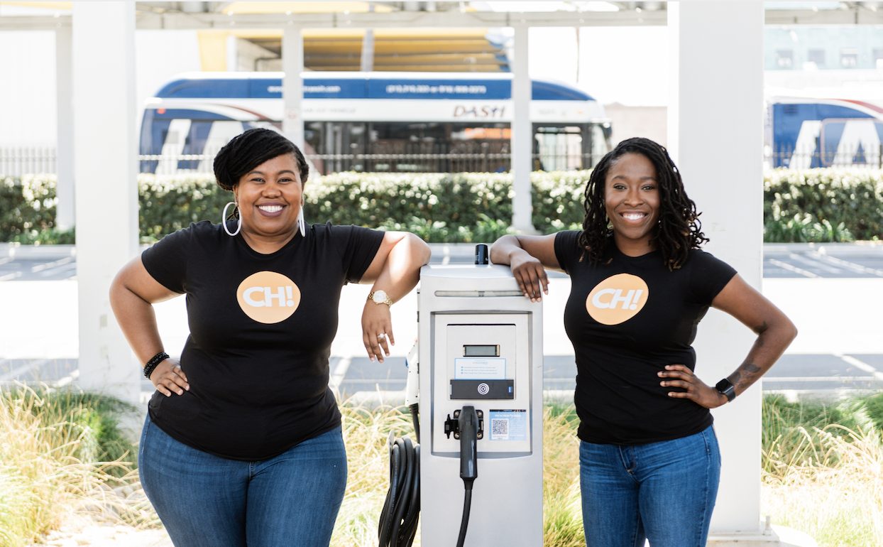 CH! Co-founders Evette Ellis (left), Chief Workforce Officer, and Kameale Terry (right), CEO, standing next to an EV charging station on a sunny day.
