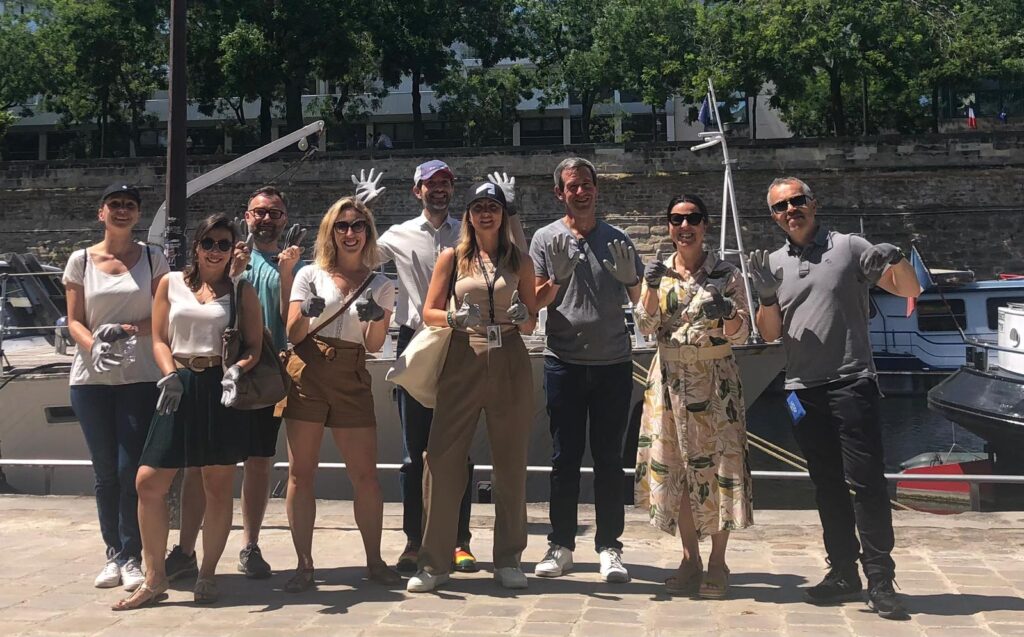 Autodesk employees in Paris collect waste from the Port de l'Arsenal while volunteering during the company’s Global Month of Impact