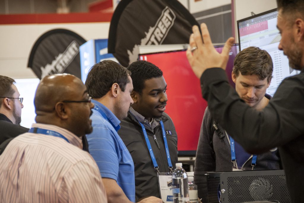 A group of people watching a product demonstration