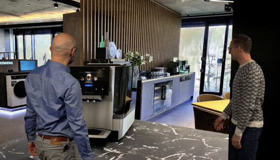 Two designers review a product in a Gaussian splat environment on a powerwall using Autodesk VRED.