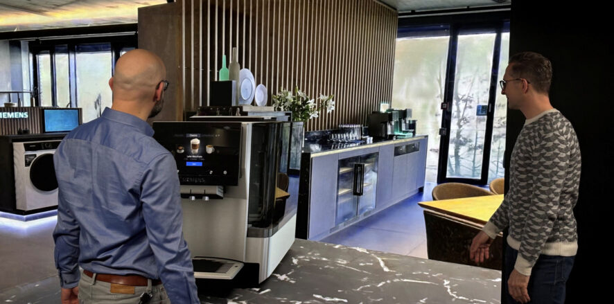 Two designers review a product in a Gaussian splat environment on a powerwall using Autodesk VRED.
