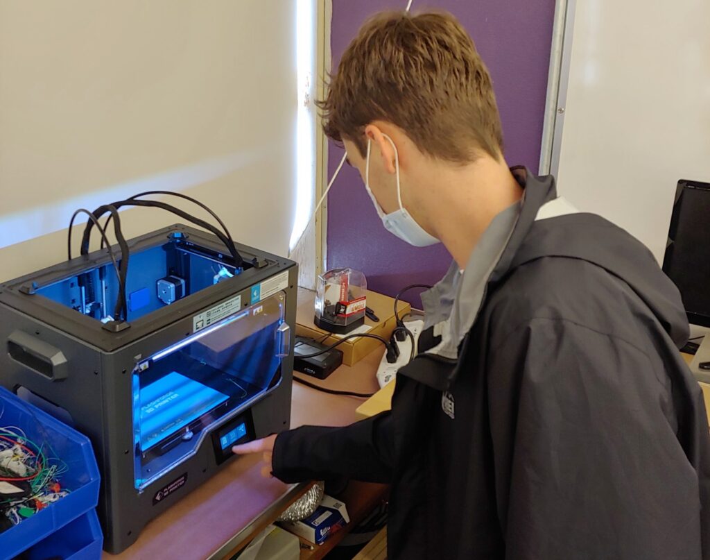 Cady Geer’s engineering student working with 3D printer