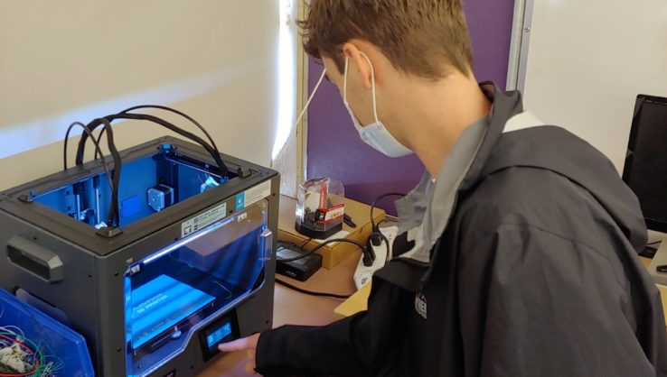Engineering student working with 3D printer