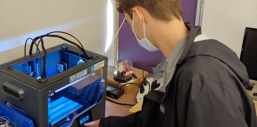 Engineering student working with 3D printer