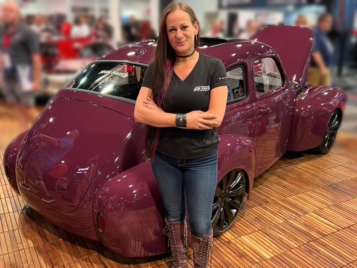 Bogi Lateiner standing in front of the Iron Maven car at SEMA