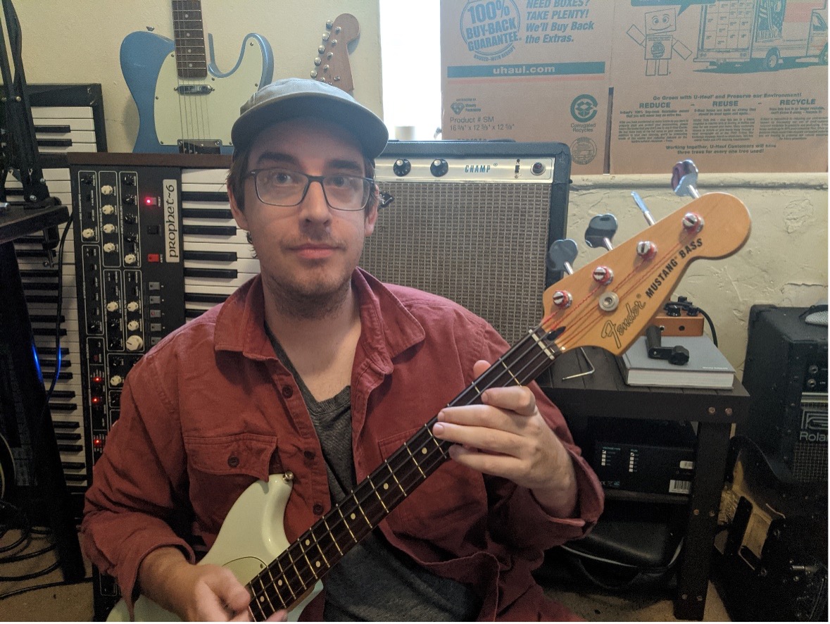 Phil Kopsaftis in front of self-repaired amplifiers and synthesizers.