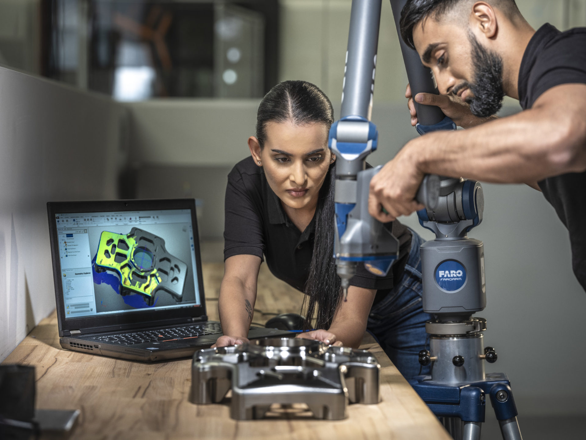 Man and woman working in a CAM lab