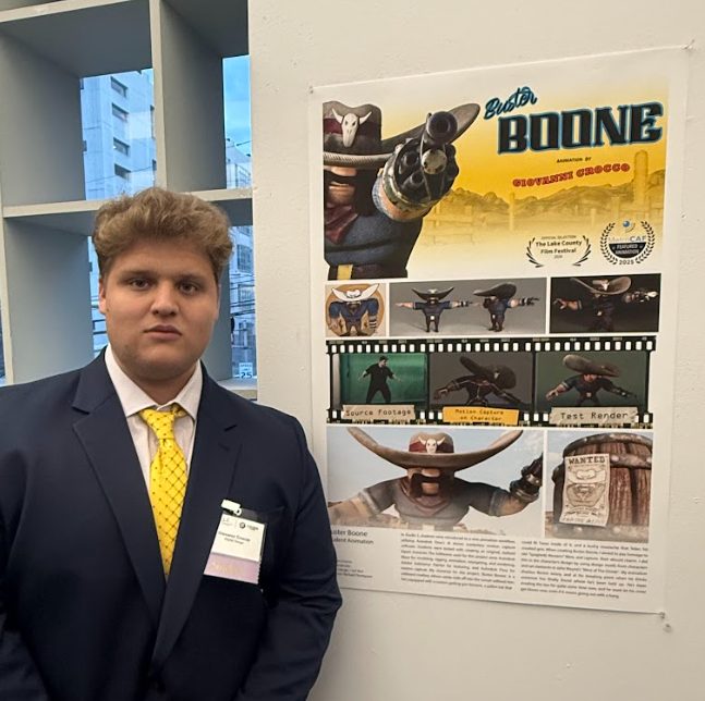 NJIT student Giovanni Crocco standing beside a poster for his animated short film, Buster Boone.
