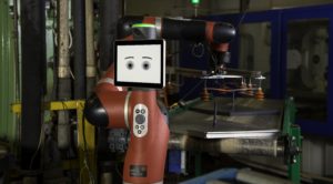 Photo of manufacturing robot with a IPad for a face.