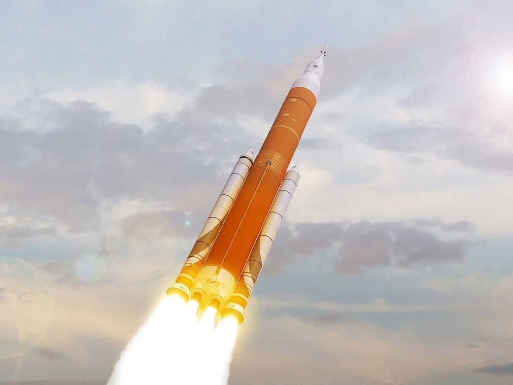 The SLS rocket, blasting off into the daytime sky.